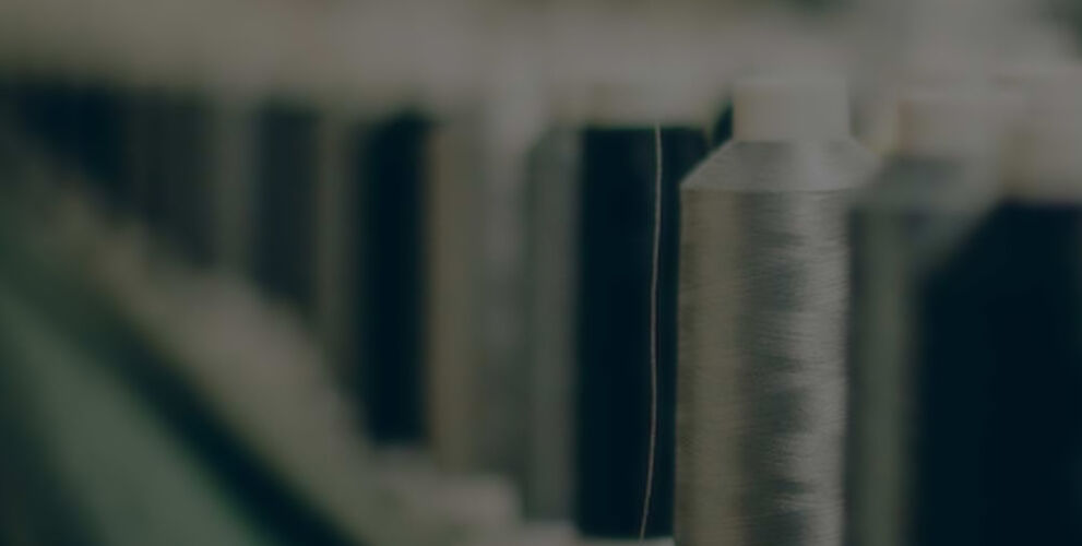 Line of various sewing threads faded to a distant blur